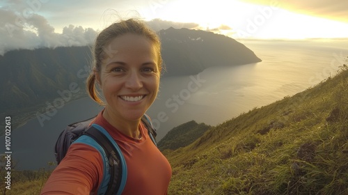 Adventurer captures joyful moment at sunrise overlooking stunning mountain lake vista photo