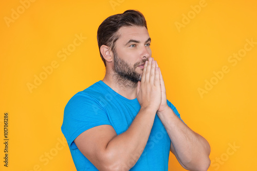 Christian Religion. Man with Praying hands praying. Isolated portrait of male pray.