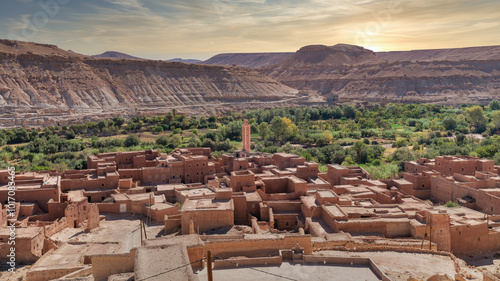 Erfoud town in the Tafilalet oasis, a tranquil desert town in Morocco surrounded by lush palm trees, blending natural beauty with traditional Moroccan architecture.