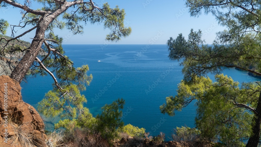 Turkish Mediterranean coastline as seen from the Lycian Way in Antalya, Turkey with a blue sea, lush green forests, and rugged rocky shores, attracting tourists every summer. Turkish Mediterranean coastline as seen from the Lycian Way in Antalya, Turkey with a blue sea, lush green forests, and rugged rocky shores, attracting tourists every summer.