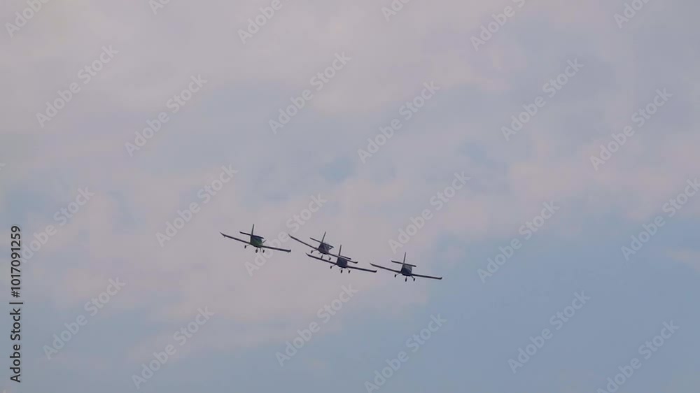 A pilot flies an aerobatic propeller plane in the sky A pilot flies an aerobatic propeller plane in the sky