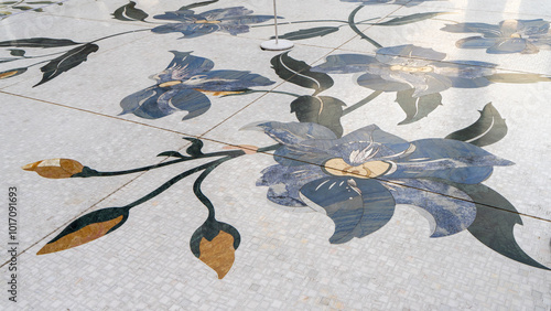 Mosaic of multicolored stone in form of blue flower on white marble floor of Sheikh Zayed Grand Mosque, Abu Dhabi, United Arab Emirates