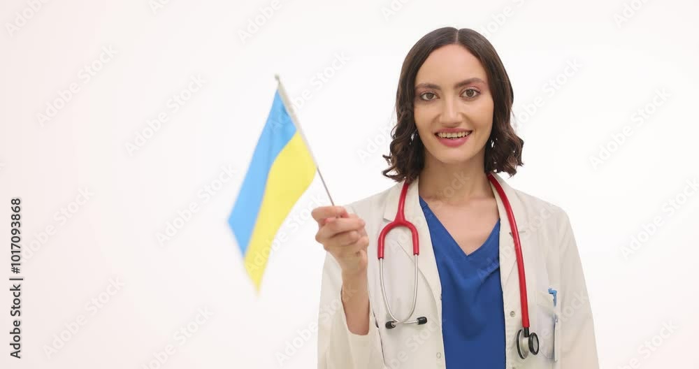 Woman doctor with stethoscope waves Ukrainian flag on white background. Cheerful female therapist supports motherland expressing pride with native people Woman doctor with stethoscope waves Ukrainian flag on white background. Cheerful female therapist supports motherland expressing pride with native people