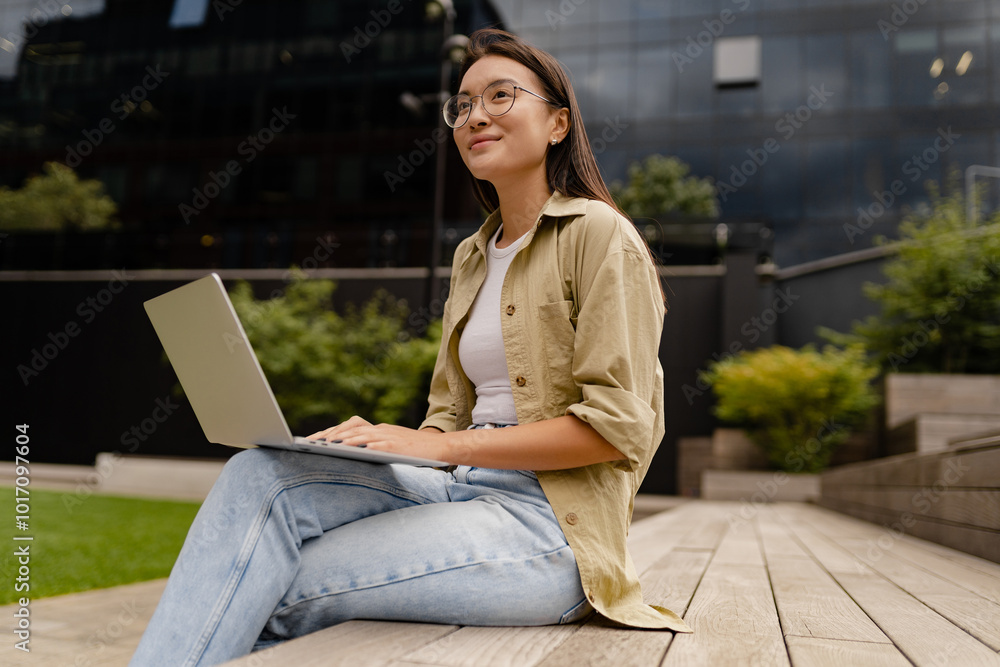 young pretty woman sitting in student campus co-working outside young pretty woman sitting in student campus co-working outside
