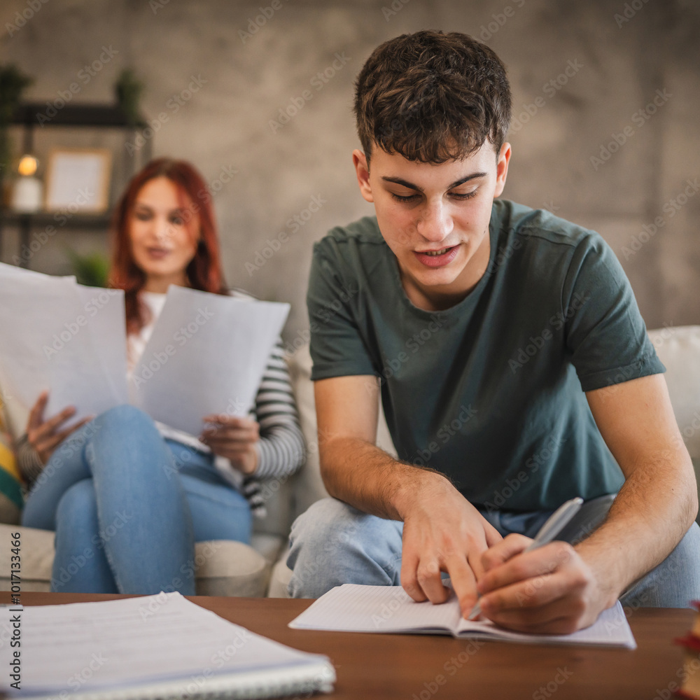 Young adult man and woman student study for exam at home Young adult man and woman student study for exam at home