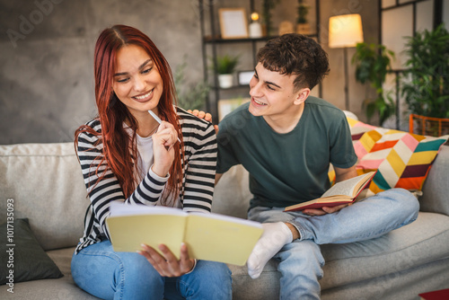 Young adult man and woman student help each other to study for exam