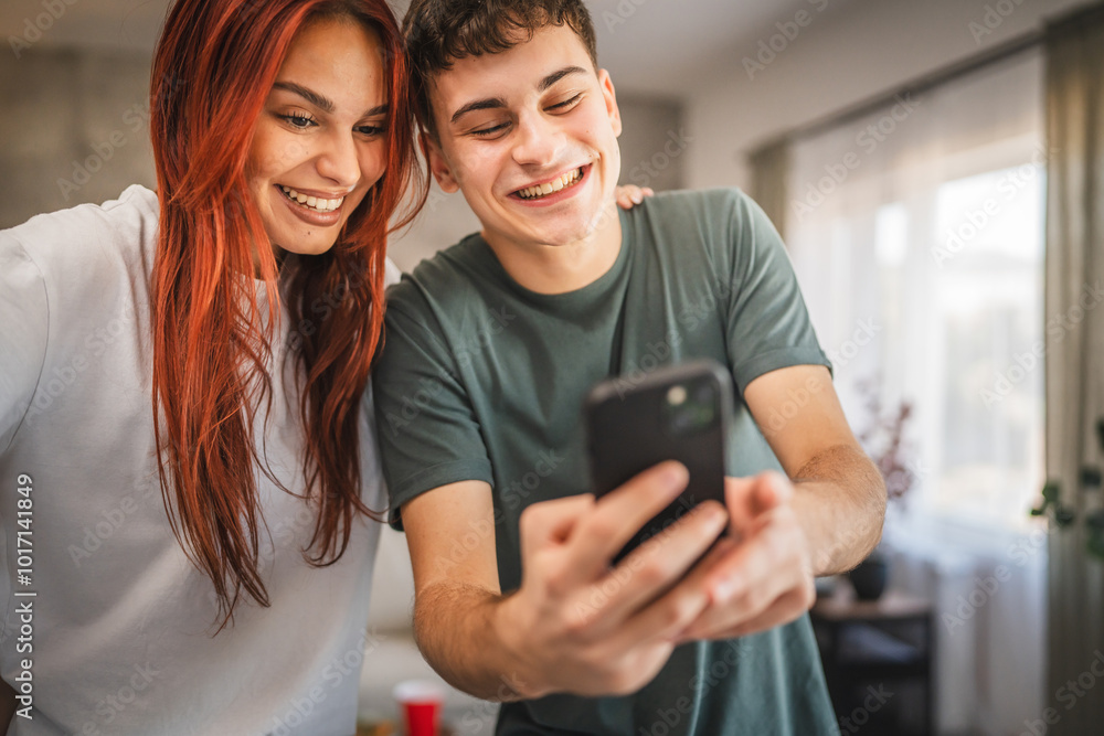 Beautiful young couple girlfriend and boyfriend use mobile at home Beautiful young couple girlfriend and boyfriend use mobile at home