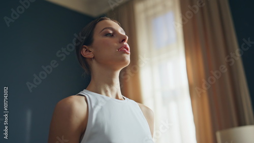 Calm yogi woman breathing preparing for yoga exercise at home room closeup.