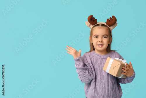 Cute little girl in reindee...