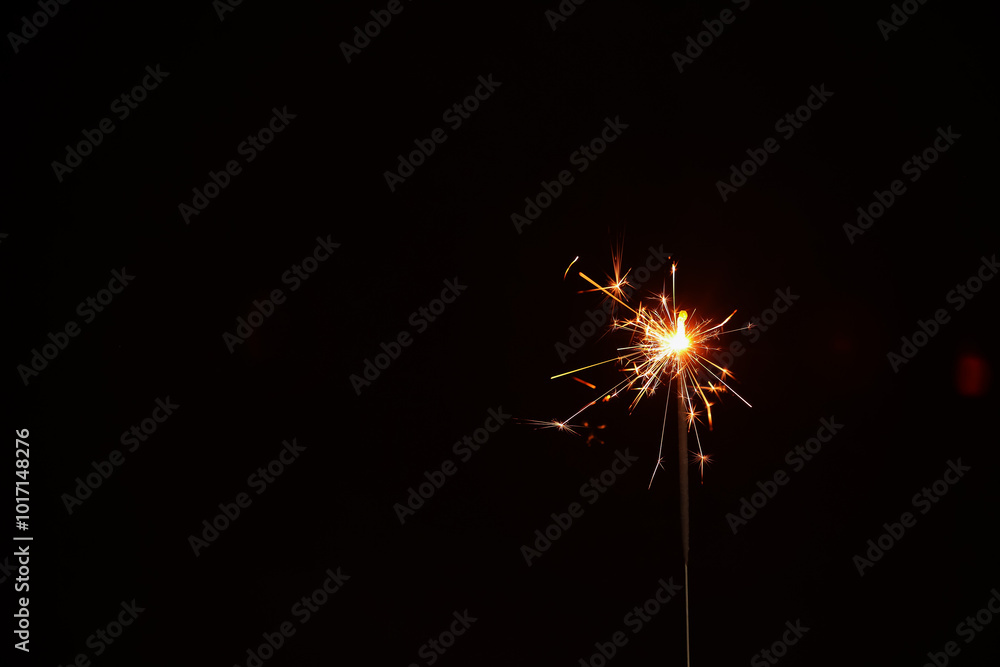 Fototapeta premium Christmas sparkler on black background