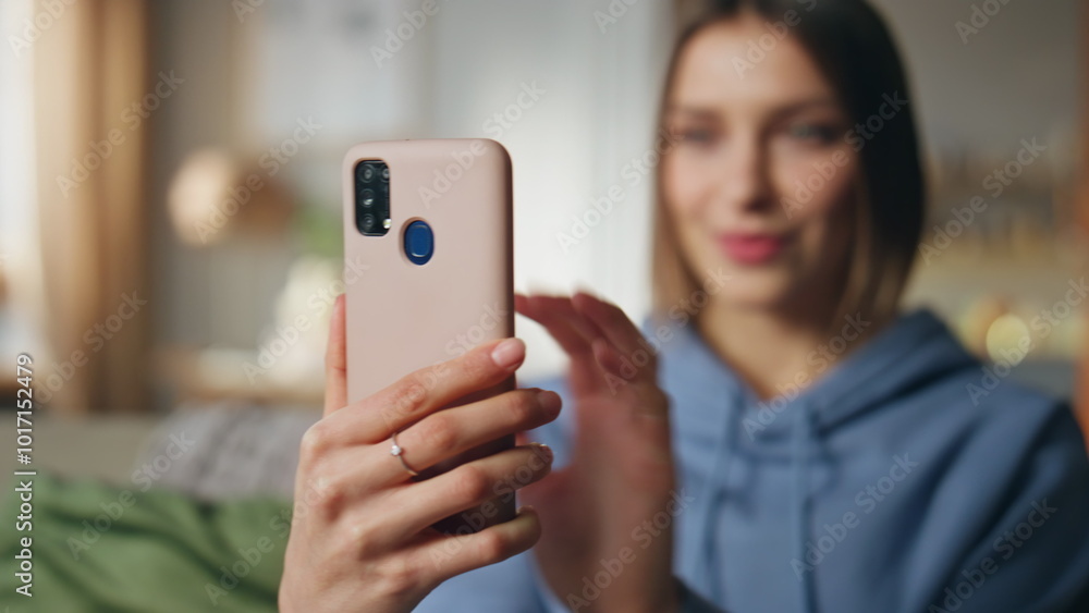 Girl blogger recording video blog at smartphone in apartment living room closeup Girl blogger recording video blog at smartphone in apartment living room closeup