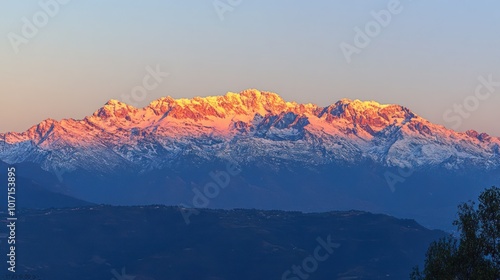 Majestic Snow-Capped Mountain Range Bathed in Golden Sunset Light