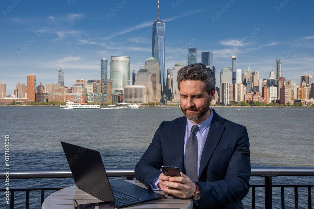 Business man using laptop computer outdoor in New York. American success Businessman . Remote freelance work. Online business in US. Business success. Management strategy. Outside business. Business man using laptop computer outdoor in New York. American success Businessman . Remote freelance work. Online business in US. Business success. Management strategy. Outside business.