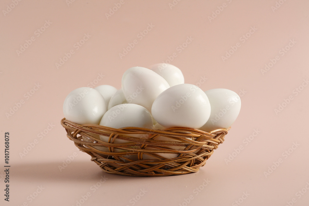 Wicker bowl with fresh boiled quail eggs on grey background Wicker bowl with fresh boiled quail eggs on grey background