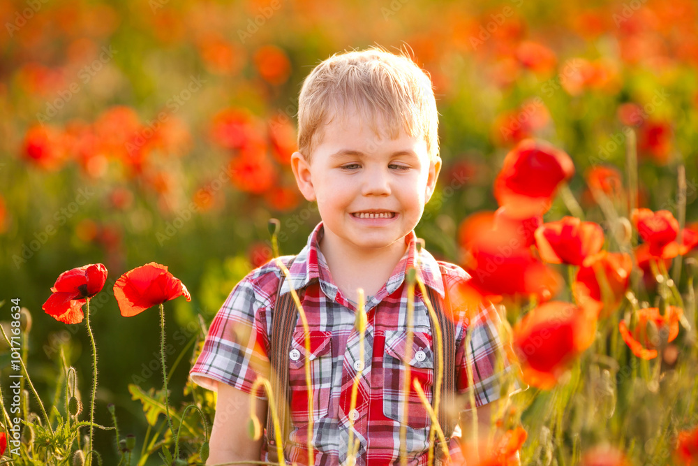 A small boy with an eye condition enjoys exploring the plants while playing in the field