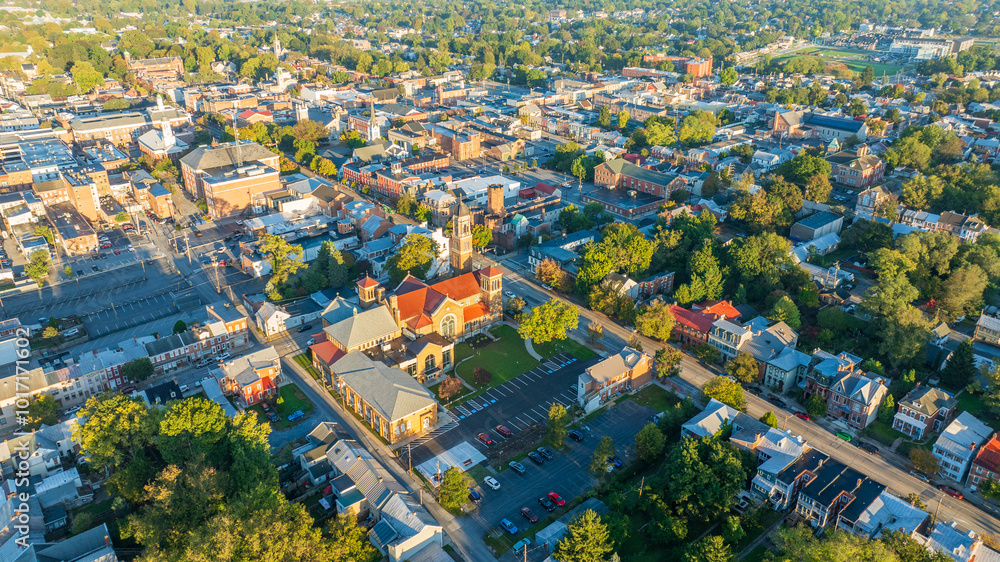 Αυτοκόλλητο Aerial view of Carlisle, PA, showcasing a mix of residential, commercial buildings, and tree-lined streets under a clear morning sky