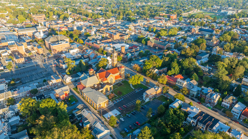 Aerial view of Carlisle, PA, showcasing a mix of residential, commercial buildings, and tree-lined streets under a clear morning sky.