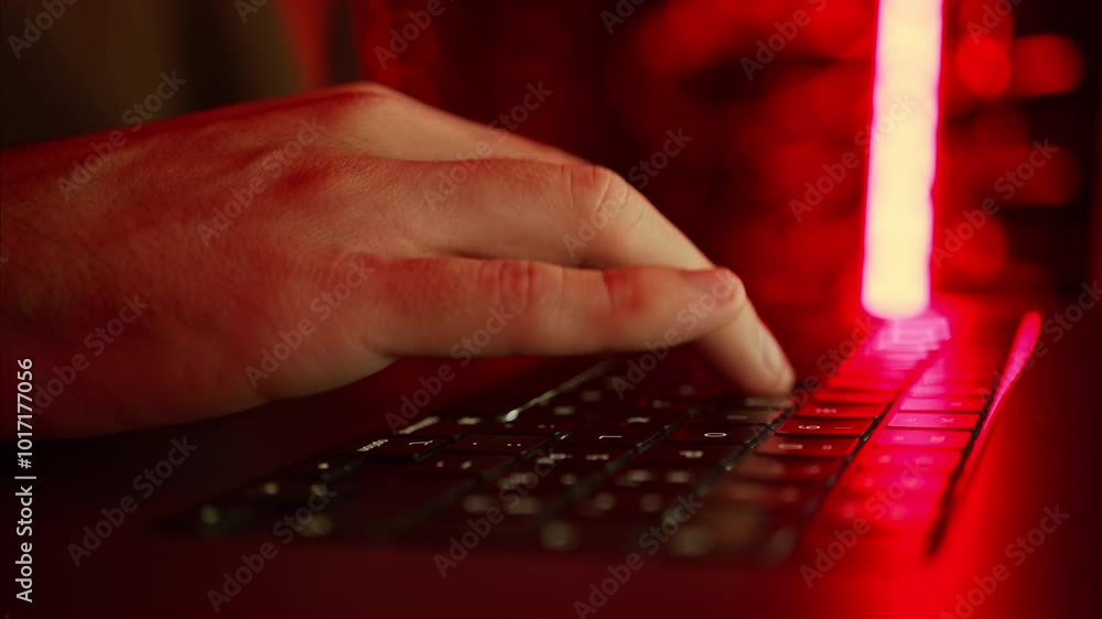 Close up of a man trying to fix an error on a computer in a server room Close up of a man trying to fix an error on a computer in a server room
