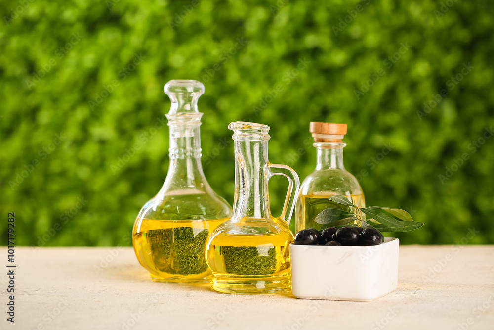 Decanters and bottle of fresh olive oil on white table outdoors Decanters and bottle of fresh olive oil on white table outdoors