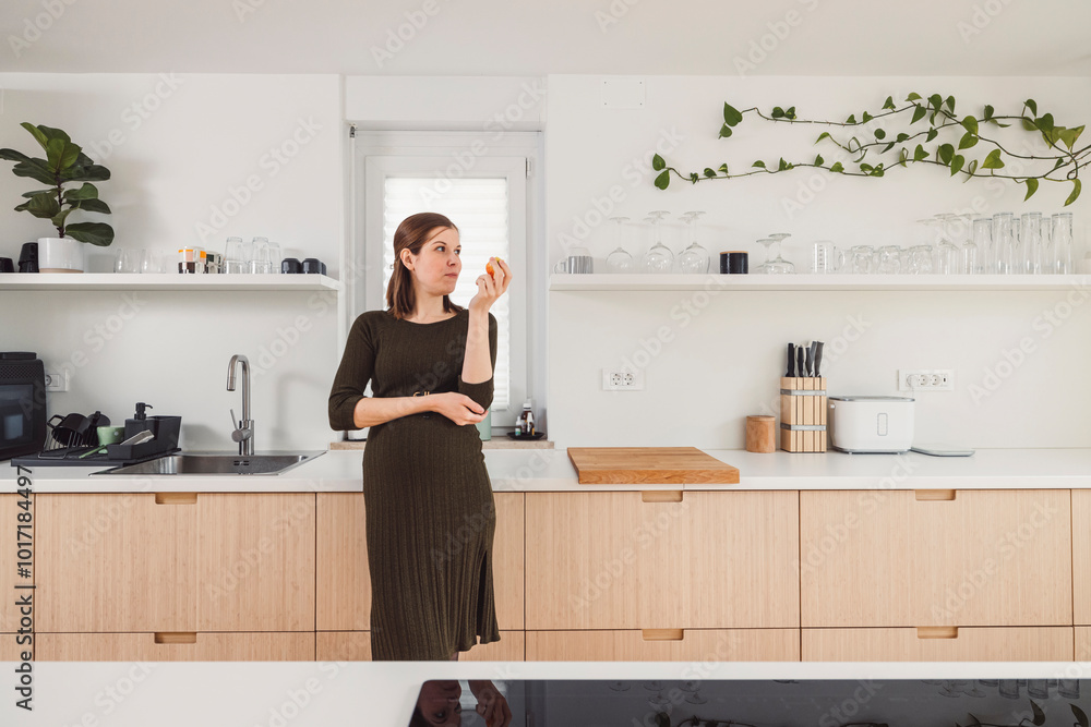 Young pregnant adult woman doing everyday things at home. Cooking, eating, sitting on couch, preparing things for the child. Young pregnant adult woman doing everyday things at home. Cooking, eating, sitting on couch, preparing things for the child.