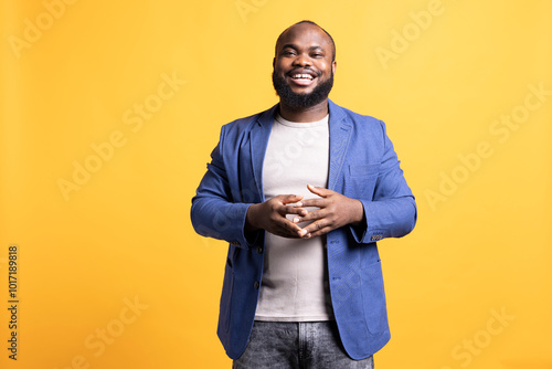 Εκτύπωση καμβά Portrait of jolly african american man posing, feeling happy, isolated over yellow studio background