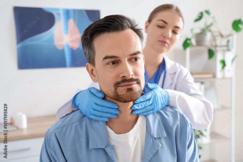 Female endocrinologist examining man's thyroid gland in clinic, closeup Female endocrinologist examining man's thyroid gland in clinic, closeup
