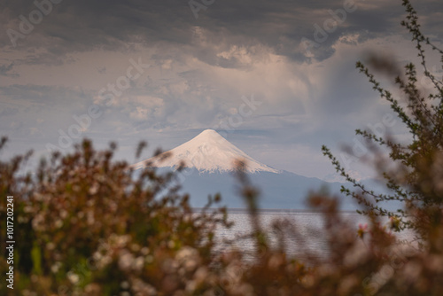 Puerto Varas, Los Lagos, Chile; may 03, 2023: Photo of snowy Osorno volcano by the lake Llanquihue seen from the town of Puerto Varas on an autumn day, Chilean Patagonia photo