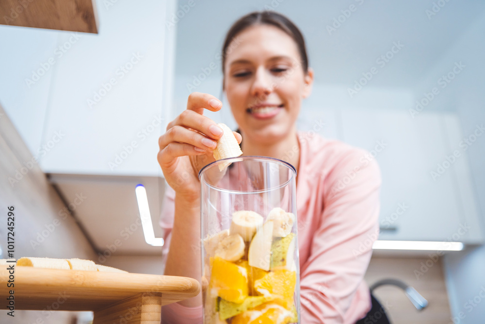 Healthy eating lifestyle concept photo of young woman preparing drink with fruit and vegetables at home in kitchen. Healthy eating lifestyle concept photo of young woman preparing drink with fruit and vegetables at home in kitchen.