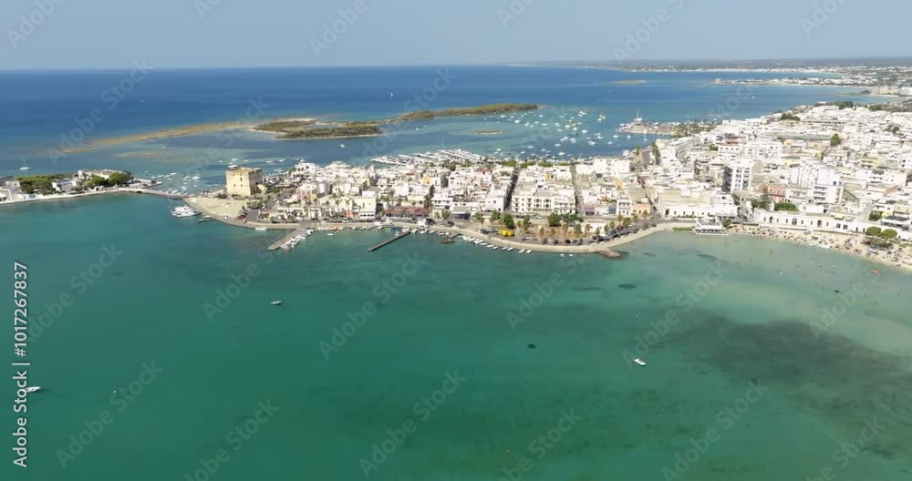Aerial view Porto Cesareo, a small city on the Mediterranean Sea in the province of Lecce in Puglia, Italy. It is a tourist town located on the Ionian coast of the Salento peninsula. Aerial view Porto Cesareo, a small city on the Mediterranean Sea in the province of Lecce in Puglia, Italy. It is a tourist town located on the Ionian coast of the Salento peninsula.