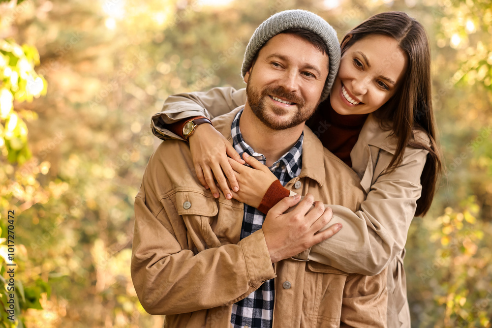 Beautiful happy couple hugging outdoors on autumn day