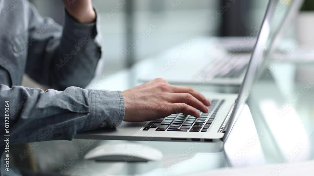 Working with a laptop and documents at a desk in close-up in the office Working with a laptop and documents at a desk in close-up in the office