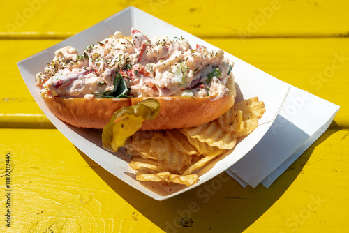 A freshly made lobster roll awaits to be eaten 