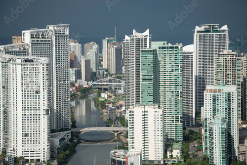 View of Metro Manila from a high condo building,lit by sunlight as storm approaches, Makati,Manila,Philippines. #1017284089