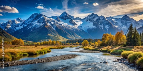 A winding river meanders through a tranquil valley, framed by majestic snow-capped mountains and a vibrant carpet of autumn foliage.