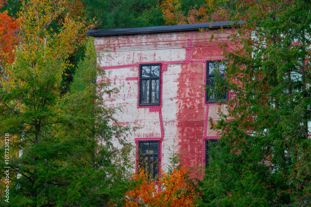 Old abandoned mill, forgotten in the heart of the Canadian forest in autumn Old abandoned mill, forgotten in the heart of the Canadian forest in autumn