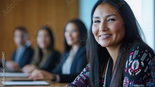 A Native American woman leading a corporate board meeting with a diverse team, celebrating diversity in leadership photo