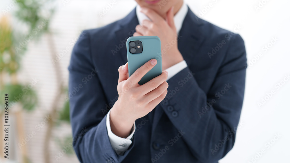 スーツを着た男性のスマートフォン スーツを着た男性のスマートフォン