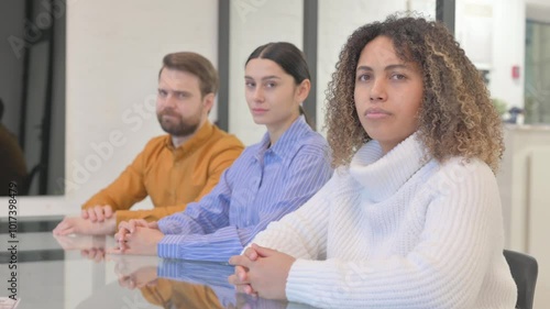 Multi Ethnic Teammates in Denial Looking at Camera in Office