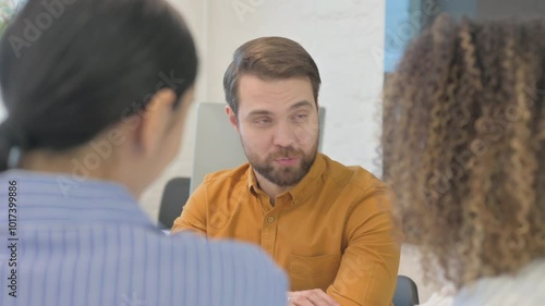 Close up of Businessman Talking with Female Teammates