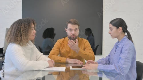 Young Entrepreneur Talking During Meeting with Multi Ethnic Teammates