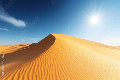 A tranquil desert landscape with golden sand dunes stretching out under a brilliant, cloudless sky. The sharp lines of the dunes cast gentle shadows photo