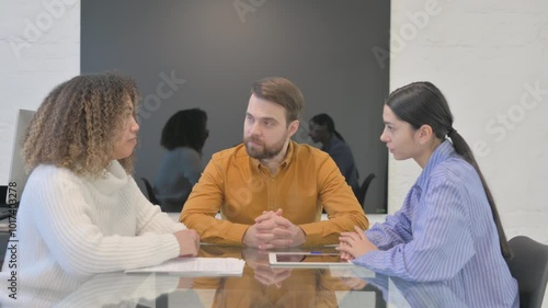 Multi Ethnic Teammates Talking During Meeting