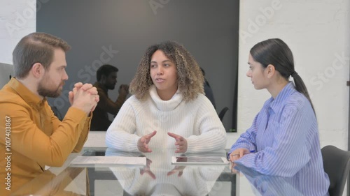 African Woman Talking with Mixed Race Team in Meeting