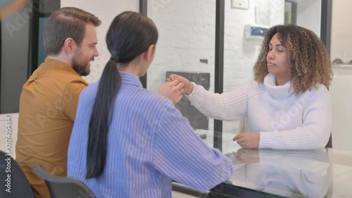 African Female Real Estate Agent Giving Home Keys to Young Couple
