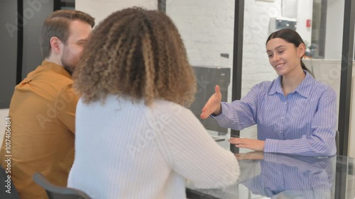 Female Real Estate Agent Giving Home Keys to Couple