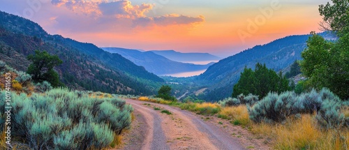 Scenic valley view with winding dirt road and vibrant sunset colors. photo