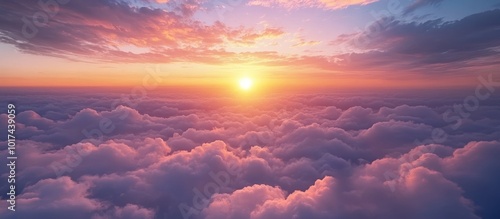 A breathtaking sunset over a sea of clouds, with a golden sun shining through the pink and orange hues of the sky.