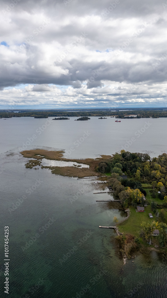Explore the breathtaking views of the 1000 Islands, where nature meets serenity. This aerial shot captures the lush greenery and sparkling waters of the St. Lawrence River, with tiny, secluded islands Explore the breathtaking views of the 1000 Islands, where nature meets serenity. This aerial shot captures the lush greenery and sparkling waters of the St. Lawrence River, with tiny, secluded islands