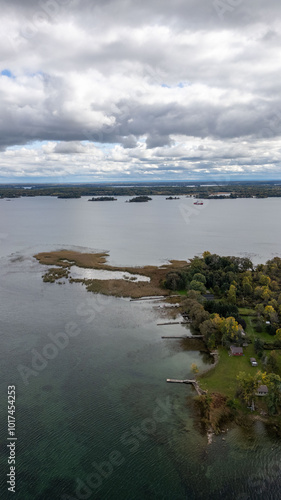 Explore the breathtaking views of the 1000 Islands, where nature meets serenity. This aerial shot captures the lush greenery and sparkling waters of the St. Lawrence River, with tiny, secluded islands