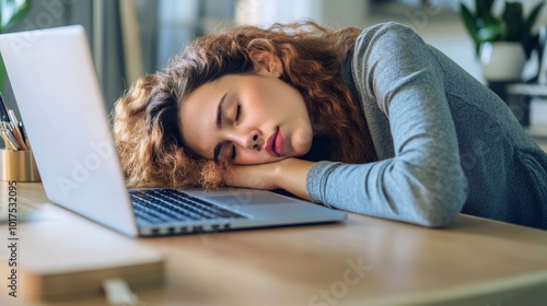 Female company employee tired or stressed from working at home until falling asleep on a desk in front of a laptopemployees who are tired or stressed from teleconferencing with the team